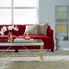 a living room with a red couch and coffee table