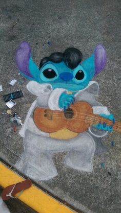 a chalk drawing of an alien playing a guitar