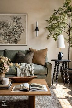 a living room filled with lots of furniture and flowers on top of a coffee table