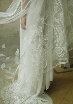 a woman in a white wedding dress and veil