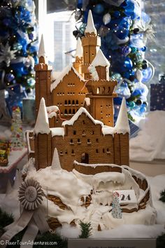 a castle made out of gingerbread with snow on the ground