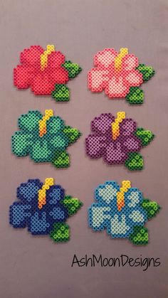 four different flowers made out of perler beads