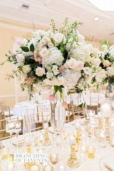 the centerpieces are filled with white and pink flowers