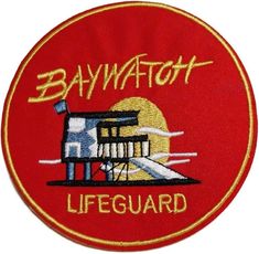 the baywatch lifeguard badge is red and yellow with an image of a lighthouse on it