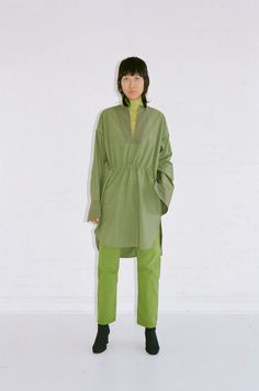 Oversize tunic shirt with open cuff and adjustable incased elastic at waistband. Side seam pockets. Info & Care 100% Cotton Dry Clean Only Made in New York Size & Fit Mimi is 5'9" and wearing a size M Spring Oversized Tunic With Shirttail Hem, Green Long Sleeve Tunic For Spring, Green Tunic For Spring Daywear, Oversized Green Tunic For Spring, Spring Workwear Tunic With Shirttail Hem, Casual Green Tunic For Fall, Green Long Sleeve Tunic For Fall, Green Long Sleeve Tunic For Daywear, Green Tunic Blouse For Fall