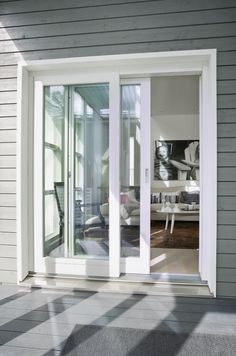 an open sliding glass door on the outside of a house