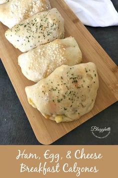 ham, egg and cheese breakfast calzones on a cutting board with a napkin