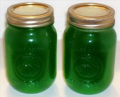 two green jars with gold lids sitting side by side