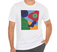 This tee features blue, red, yellow, and green abstract shapes with design elements that have been put together in an abstract collage. Stand out from the others with this bright and colorful t-shirt.  This makes a great gift for the art teacher, for the contemporary art lover, or for the art enthusiast.   This classic unisex jersey short sleeve tee fits like a well-loved favorite. Soft cotton and quality print make users fall in love with it over and over again. These t-shirts have-ribbed knit collars to bolster shaping. The shoulders are tapered for a better fit over time. Dual side seams hold the garment's shape for longer.  .: Made with 100% Airlume combed and ring-spun cotton, a lightweight fabric (4.2 oz/yd² (142 g/m that is easy to layer, breathable. Perfect for active and leisure w Multicolor Abstract Print Casual T-shirt, Artsy Short Sleeve T-shirt With Artwork, Artistic Multicolor Crew Neck T-shirt, Artsy Short Sleeve Tops With Artwork, Artistic Cotton T-shirt With Abstract Print, Artsy Multicolor Screen Print T-shirt, Casual Multicolor Abstract Print T-shirt, Casual Summer T-shirt With Artwork, Multicolor Crew Neck T-shirt With Abstract Print