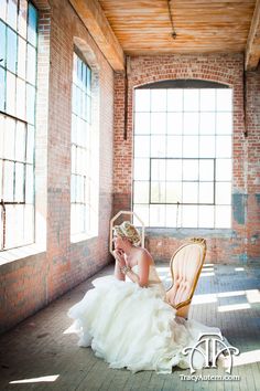 a woman in a wedding dress sitting on a chair