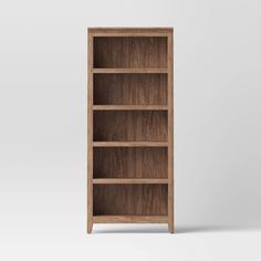 an empty wooden bookcase on a white background