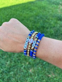 Sports mamas Customize this stack with your kid's name, number, and team colors! We can do all sports! If you have more than one kid playing, send us a message and we can send you a custom listing so you can represent all your littles  Bracelets are made with elastic string, clay disc beads, and 14K gold filled beads. Please see picture for sizing instructions. Make sure to add colors, name, and number to personalization. Soccer Bracelets Clay Beads, Personalized Blue Bracelets For Game Day, Personalized Blue Bracelets For Sports Events, Blue Team Spirit Jewelry For Game Day, Blue Beaded Bracelets With Letter Beads For Team Spirit, Blue Adjustable Beaded Bracelets For Team Spirit, Blue Adjustable Bracelets For Team Spirit, Personalized Team Spirit Wristband For Sports, Personalized Team Spirit Wristband For Sports Events