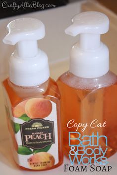 two bottles of soap sitting next to each other on a bathroom counter with peaches