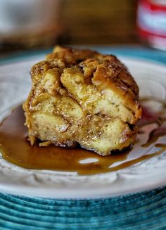 a piece of cake sitting on top of a white plate covered in caramel sauce