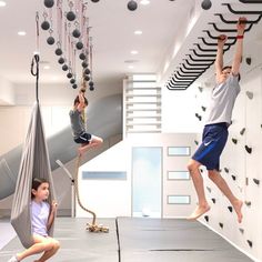 two children are playing in a climbing gym