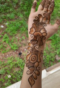 the hand is decorated with henna on it