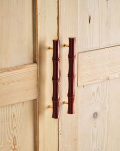 two wooden handles on the side of a door