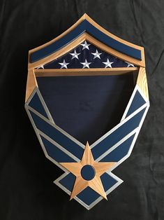 a wooden plaque with an air force emblem on it's side and stars in the middle