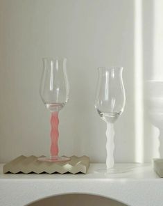 two empty wine glasses sitting on top of a counter