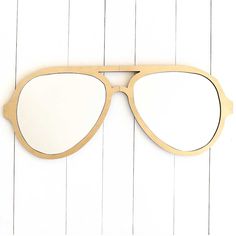 a pair of glasses sitting on top of a white wall