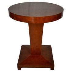 a round wooden table with two pedestals on each side and an oval shaped top