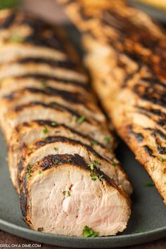 grilled meat on a plate with parsley sprinkled around it's edges