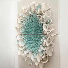 a piece of art made out of white and blue paper