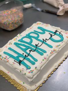 a birthday cake with the words happy birthday written in frosting on it and sprinkles