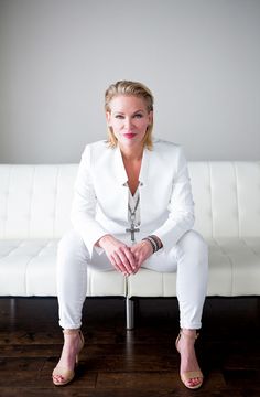 a woman sitting on top of a white couch