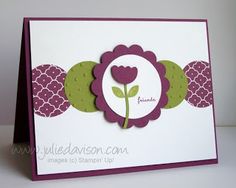 a close up of a card with a flower on the front and bottom corner,