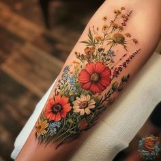 a woman's arm with flowers on it