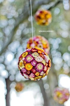 an ornament hanging from a tree filled with flowers