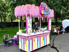 an ice cream stand with people sitting at it