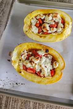 two stuffed peppers sitting on top of a pan