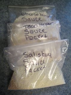 three bags of salt sitting on top of a counter next to each other with writing on them