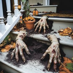 three hands with dirty paint on them are sitting on the steps in front of a house