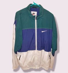 THIS JACKET IS IN EXCELLENT CONDITION, EXTREMELY CLEAN, & WELL KEPT VINTAGE, OFFICIALLY LICENSED, GENUINE, NIKE FULL ZIPPER WINDBREAKER JACKET MADE OF THE FOLLOWING:      BODY 100% NYLON     LINER 35% COTTON 65% POLYESTER SIZE MENS LT APPROX. MEASURMENTS: LENGTH (TOP TO BOTTOM) 29.5" & WIDTH (PIT TO PIT) 24" EXPRESS & INTERNATIONAL SHIPPING AVAILABLE ITEM SHIPS WITHIN 1 BUSINESS DAY PLEASE FEEL FREE TO ASK ANY QUESTIONS 90s Green Sports Windbreaker, 90s Green Sports Outerwear, 90s Style Green Track Jacket For Sports, Nike Green Casual Windbreaker, Casual Green Nike Windbreaker, Nike Green Sportswear Windbreaker, Green Nike Track Jacket For Streetwear, Green Nike Windbreaker For Sports, Nike Green Casual Track Jacket