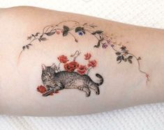 a cat with flowers on it's arm