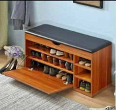 a wooden shoe rack with several pairs of shoes on it