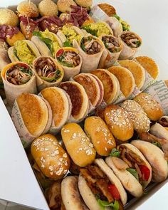 an assortment of sandwiches are displayed in a box