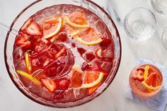 a drink with oranges and strawberries in it