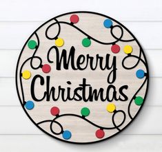 a merry christmas sign hanging on the side of a wall