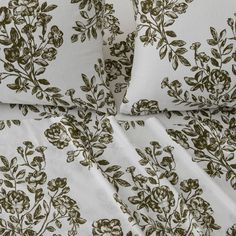 an image of a bed with white and brown flowers on it's sheet set