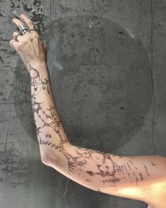 a woman's arm with writing all over it and a ring on the finger