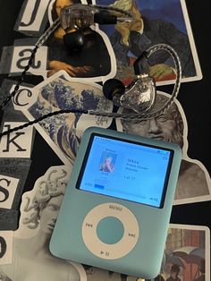 an ipod sitting on top of a table next to stickers and magnets in front of it