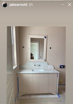 a bathroom with a sink and mirror in it