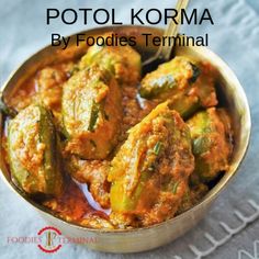 a bowl full of food with a spoon in it and the words potol korma written below