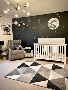 a baby's room decorated in black, white and grey with stars on the wall