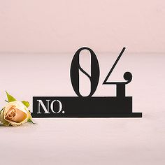 there is a sign that says no with a rose on the table next to it