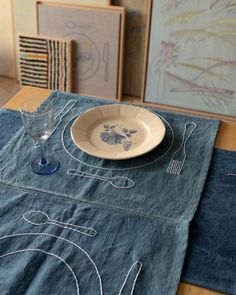 a place setting on a table with blue linens